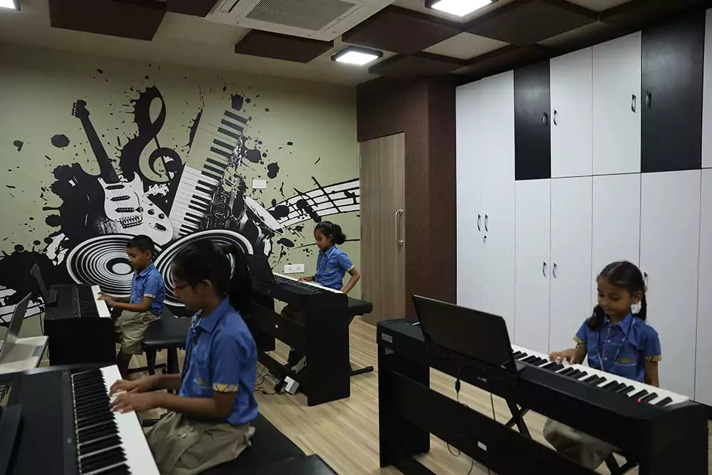 Students of KES International school playing piano keyboard